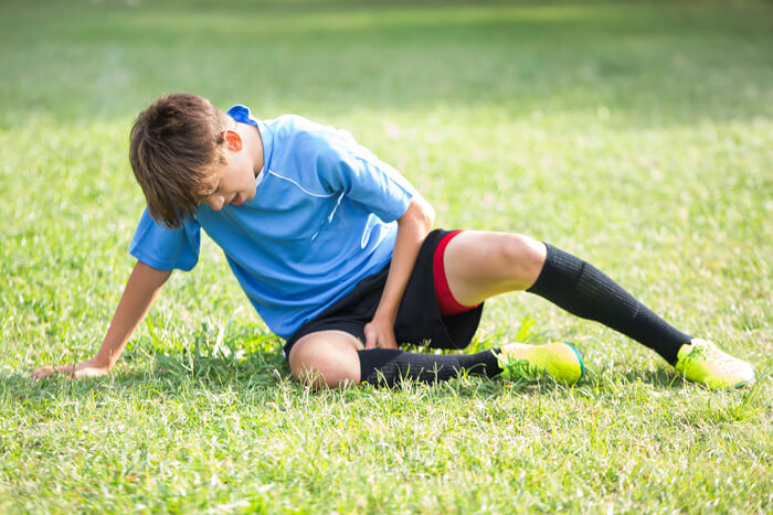 Boy on ground with injury