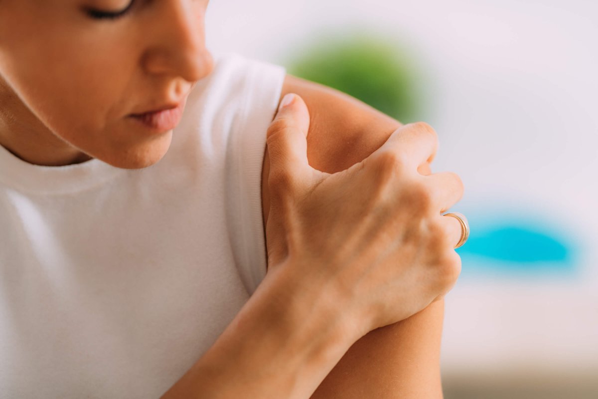 Woman massaging painful shoulder